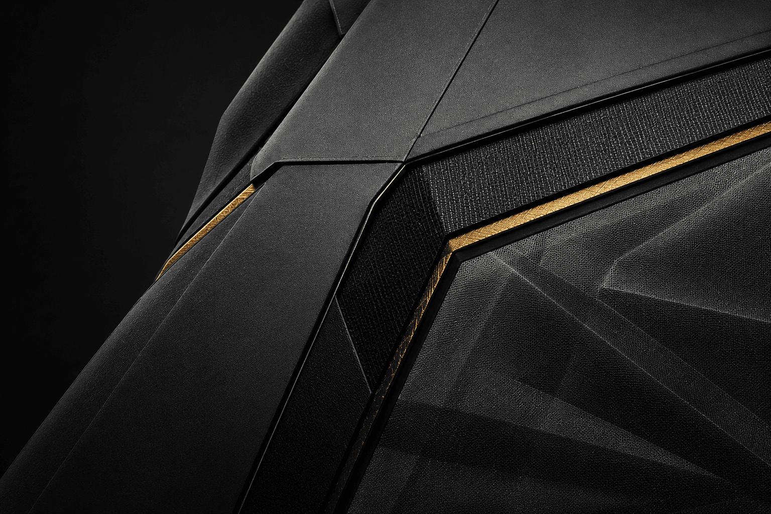 Close-up of a black technical garment with gold structural detailing